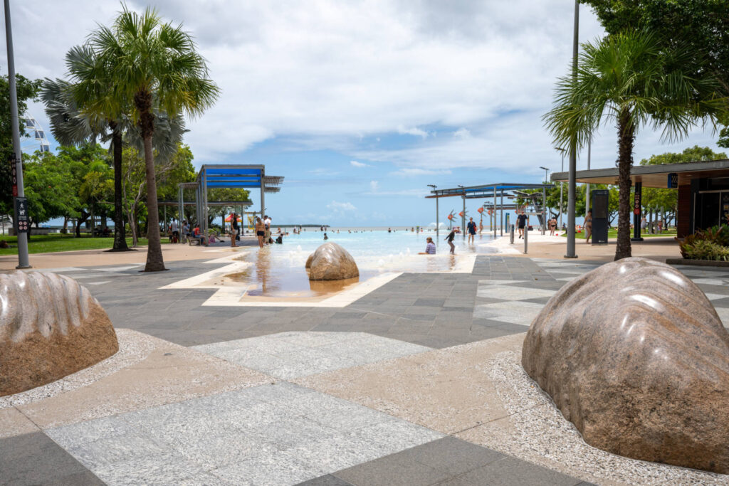 Palm trees and sculptures beside the saltwater Esplanade Lagoon in Cairns