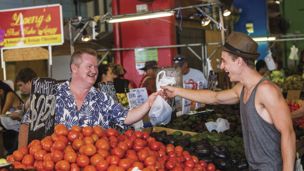 Shoppers buying fresh produce at Rusty's Markets in Cairns