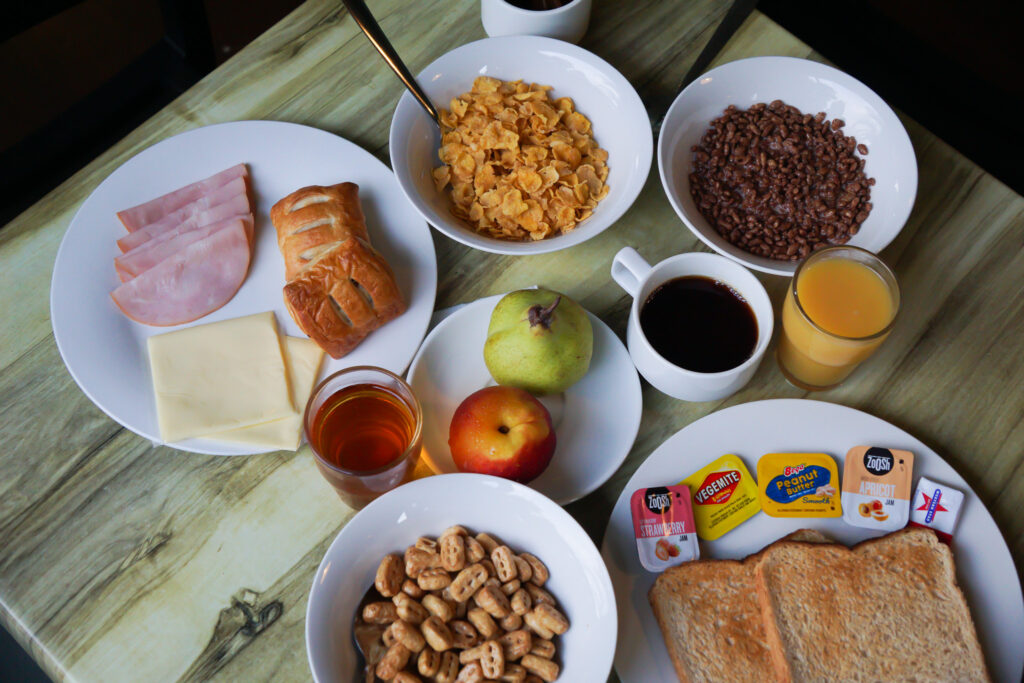 breakfast set up with pastries, cereal, coffee, tea, and juice